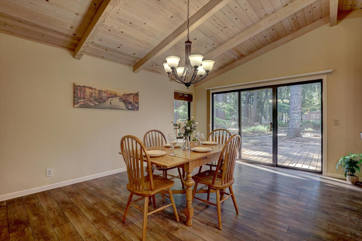 12523 Banner Lava Cap Road Nevada City, CA 95959 - Photo 9 of 57 a view of a dining room with furniture a chandelier and wooden floor