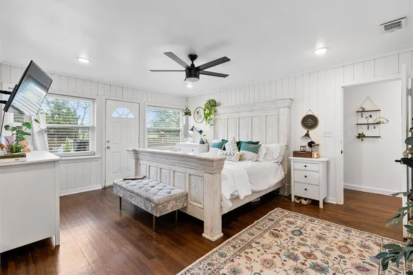 a bed room with furniture and wooden floor