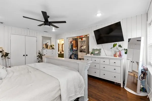 a bedroom with a bed and a flat screen tv