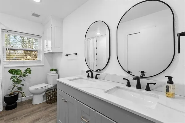 a bathroom with a toilet a sink and a mirror