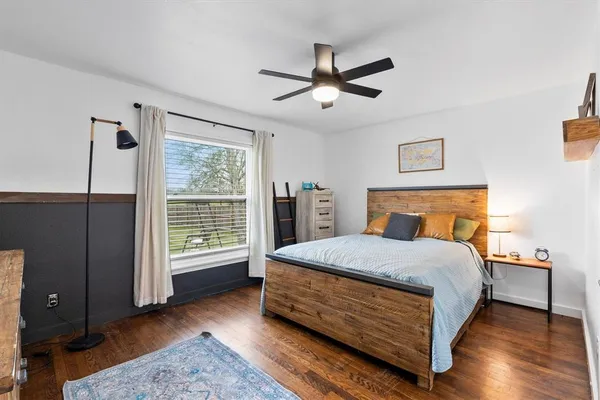a bed sitting in a bedroom next to a window