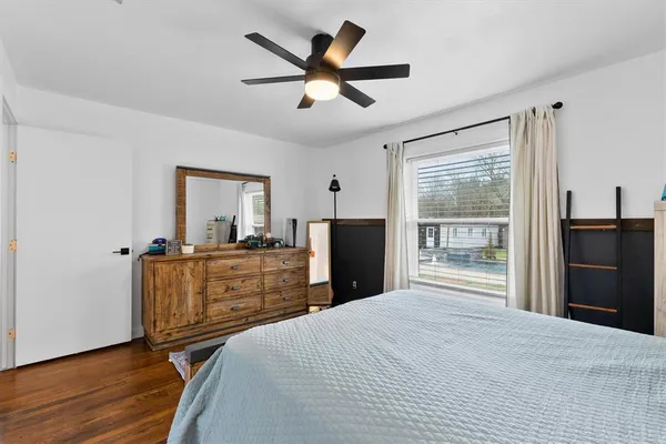 a bedroom with a bed and a dresser