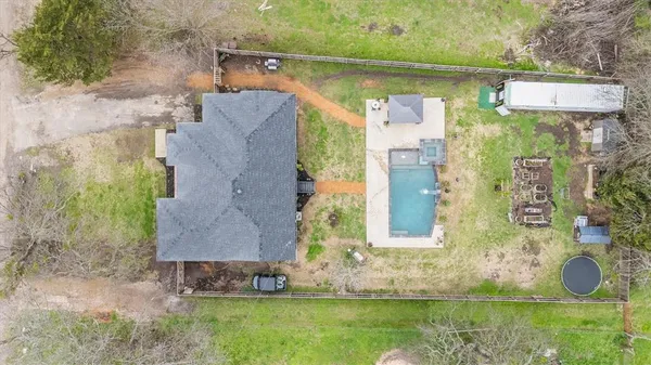 an aerial view of residential house with outdoor space and swimming pool