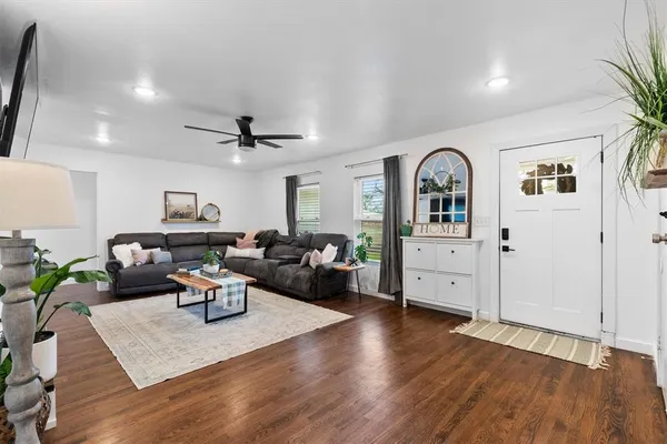a living room with furniture or couch and a wooden floor