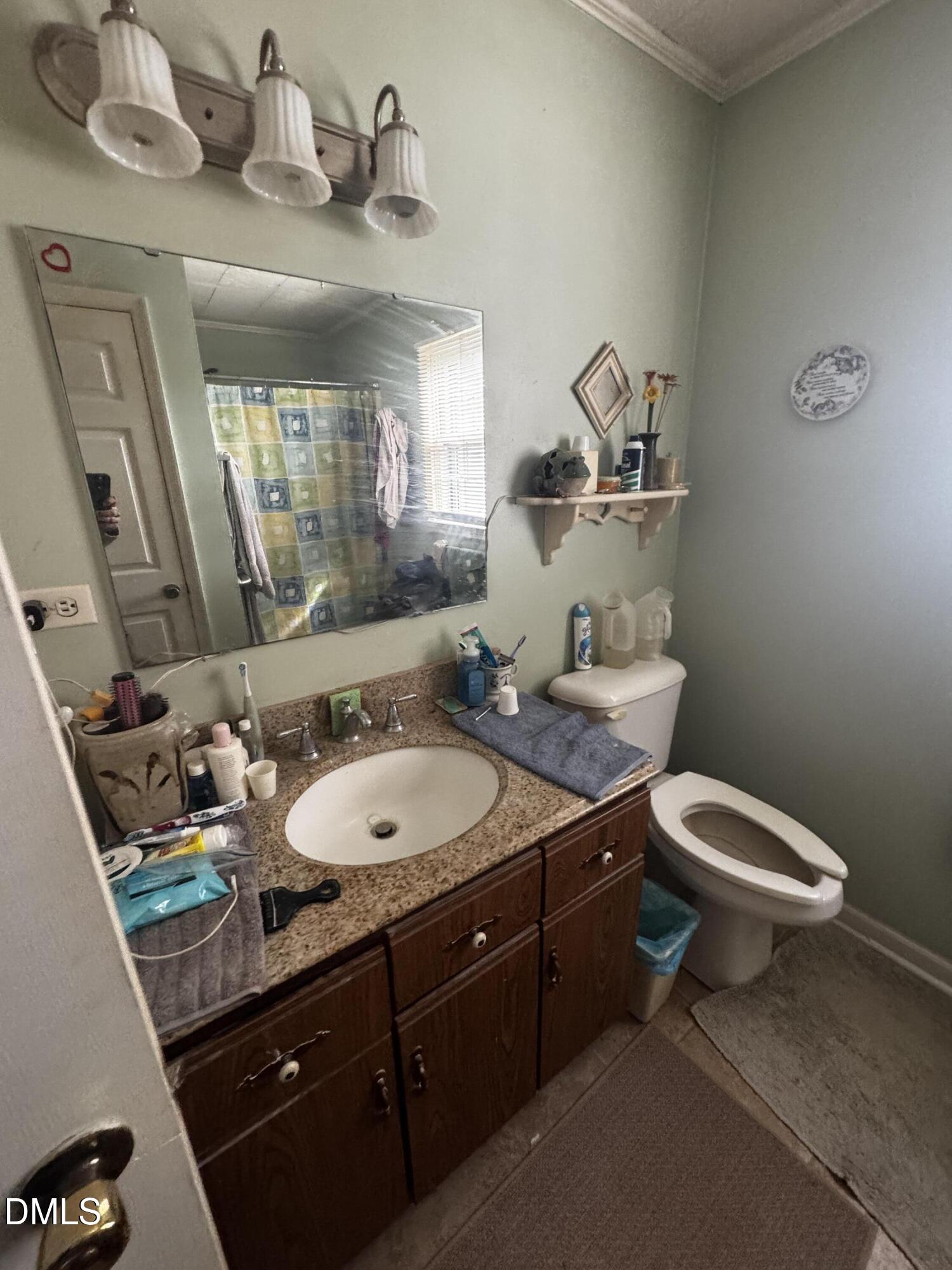 4229 Old Faison Road Knightdale, NC 27545 - Photo 6 of 16 a bathroom with a granite countertop sink a toilet and a mirror