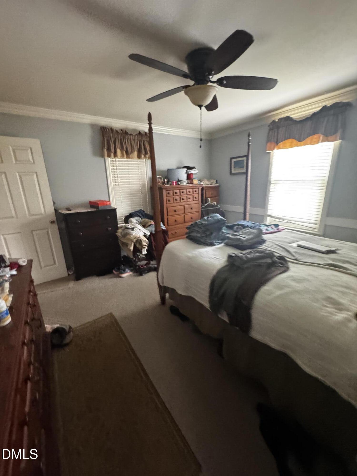 4229 Old Faison Road Knightdale, NC 27545 - Photo 7 of 16 a bedroom with bed and a chandelier