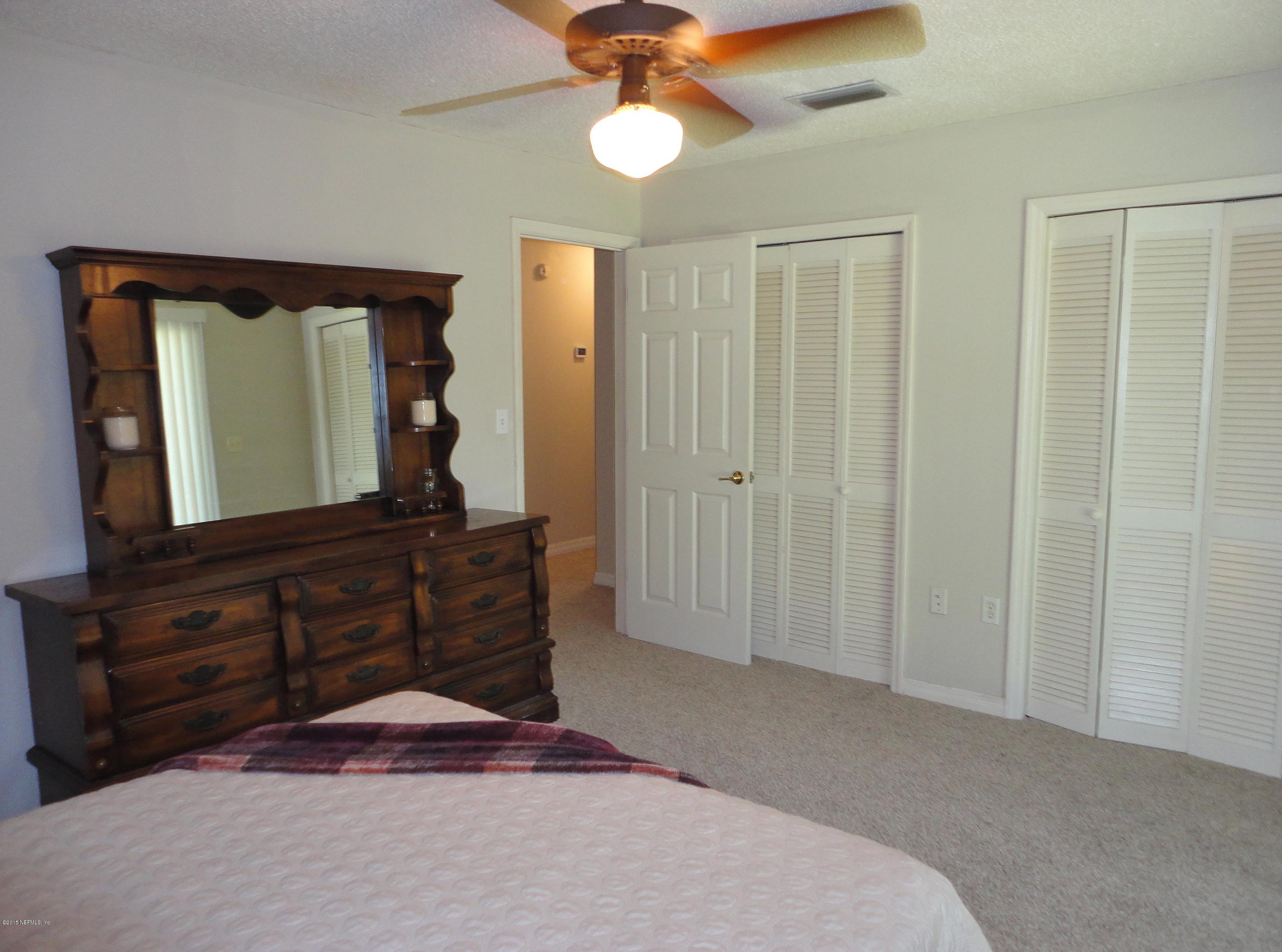 1005 San Jose Road St. Augustine, FL 32086 - Photo 13 of 29 a bedroom with a bed and a dresser