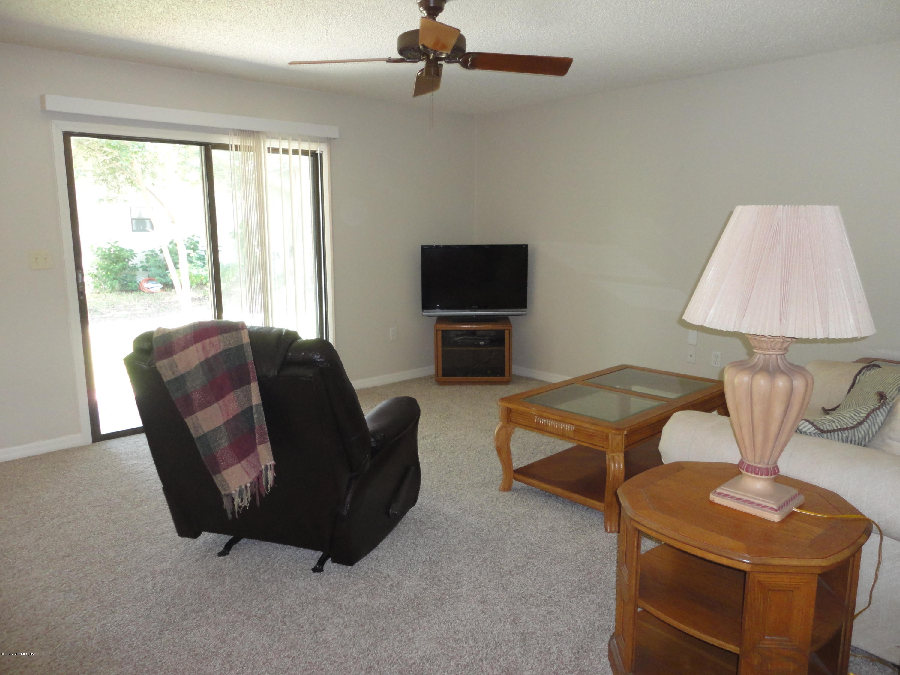 1005 San Jose Road St. Augustine, FL 32086 - Photo 5 of 29 a living room with furniture a flat screen tv and a window
