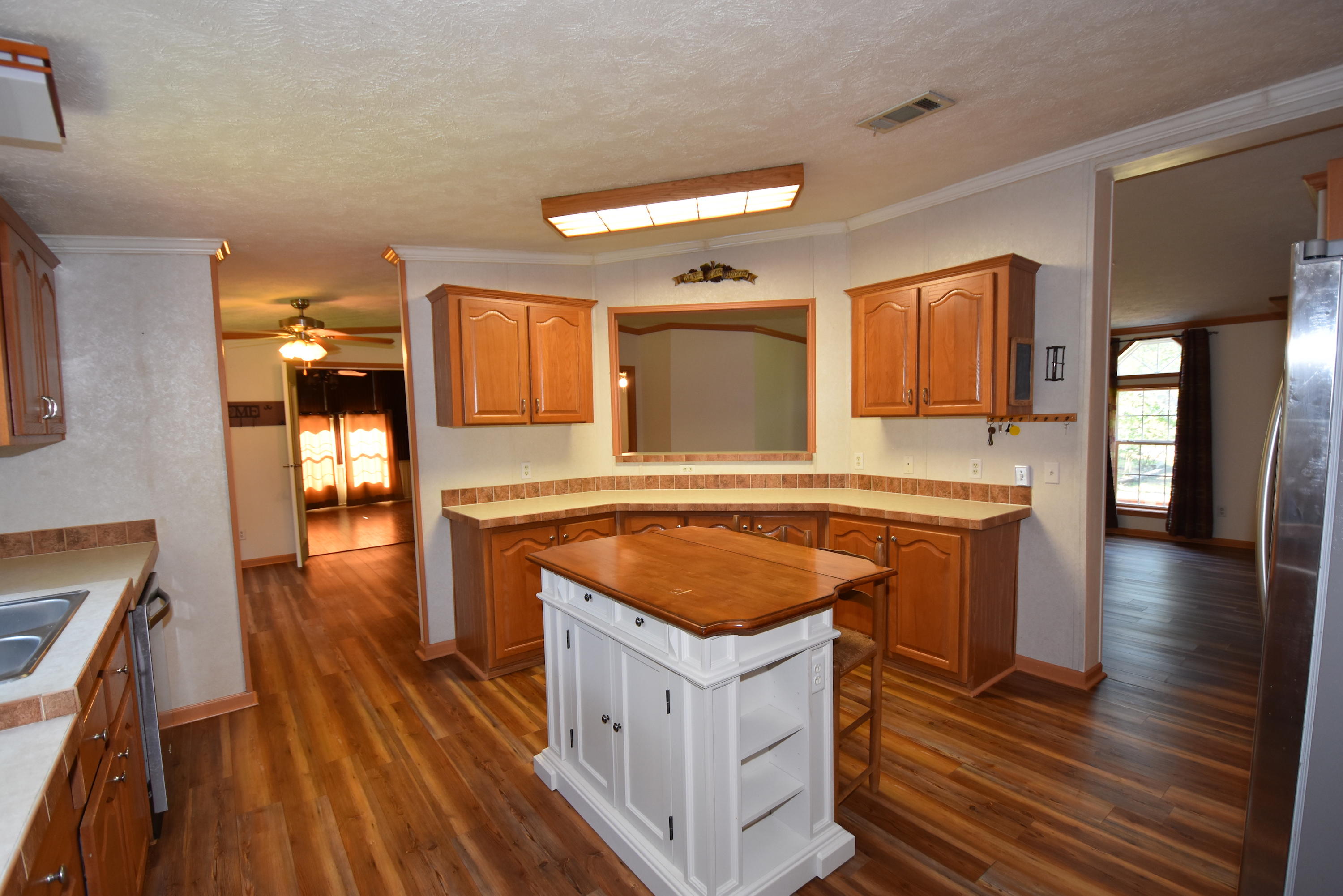 2953 Adams Road Crestview, FL 32536 - Photo 17 of 51 a kitchen with stainless steel appliances granite countertop a stove and a wooden floors