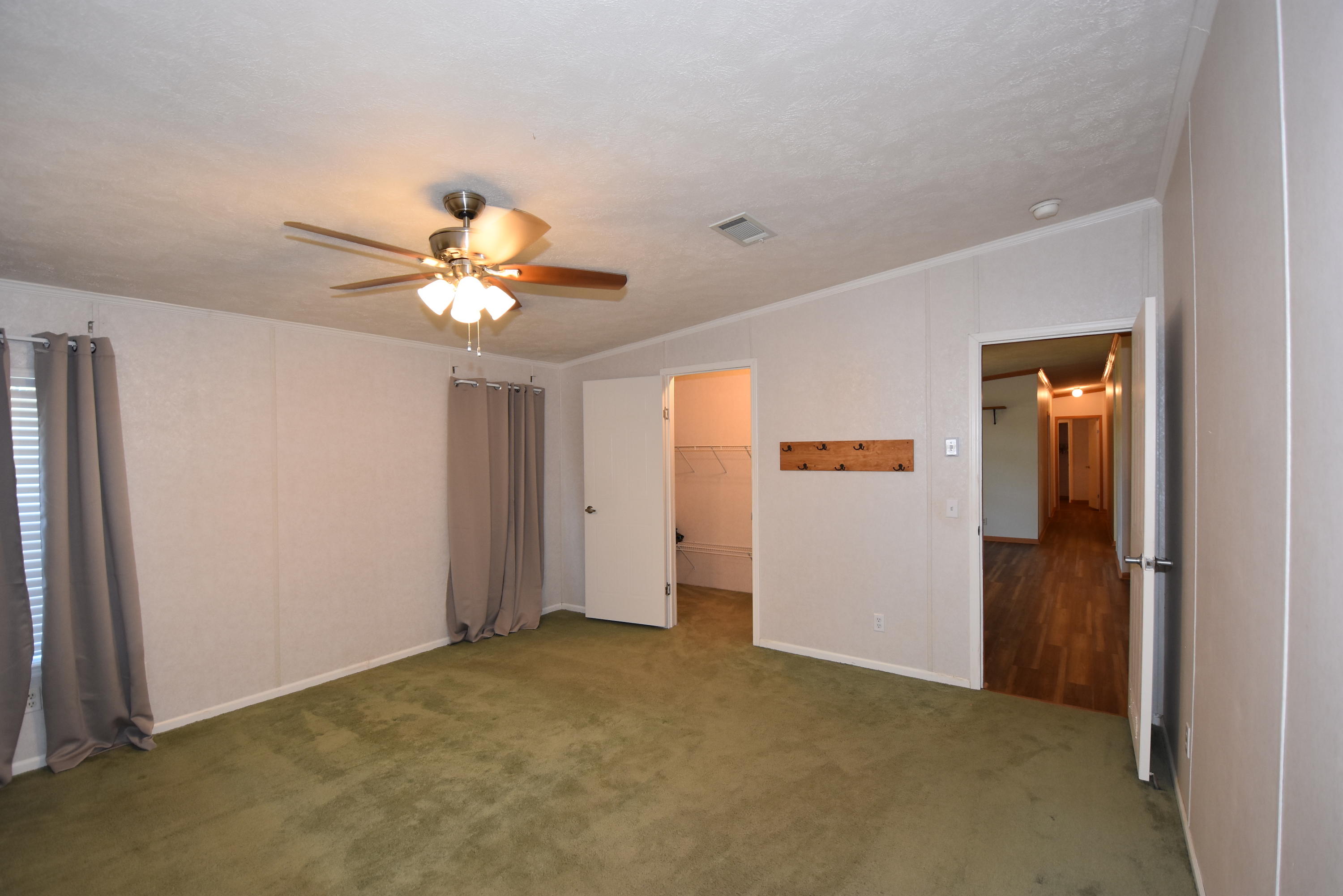 2953 Adams Road Crestview, FL 32536 - Photo 21 of 51 wooden floor in an empty room with a window