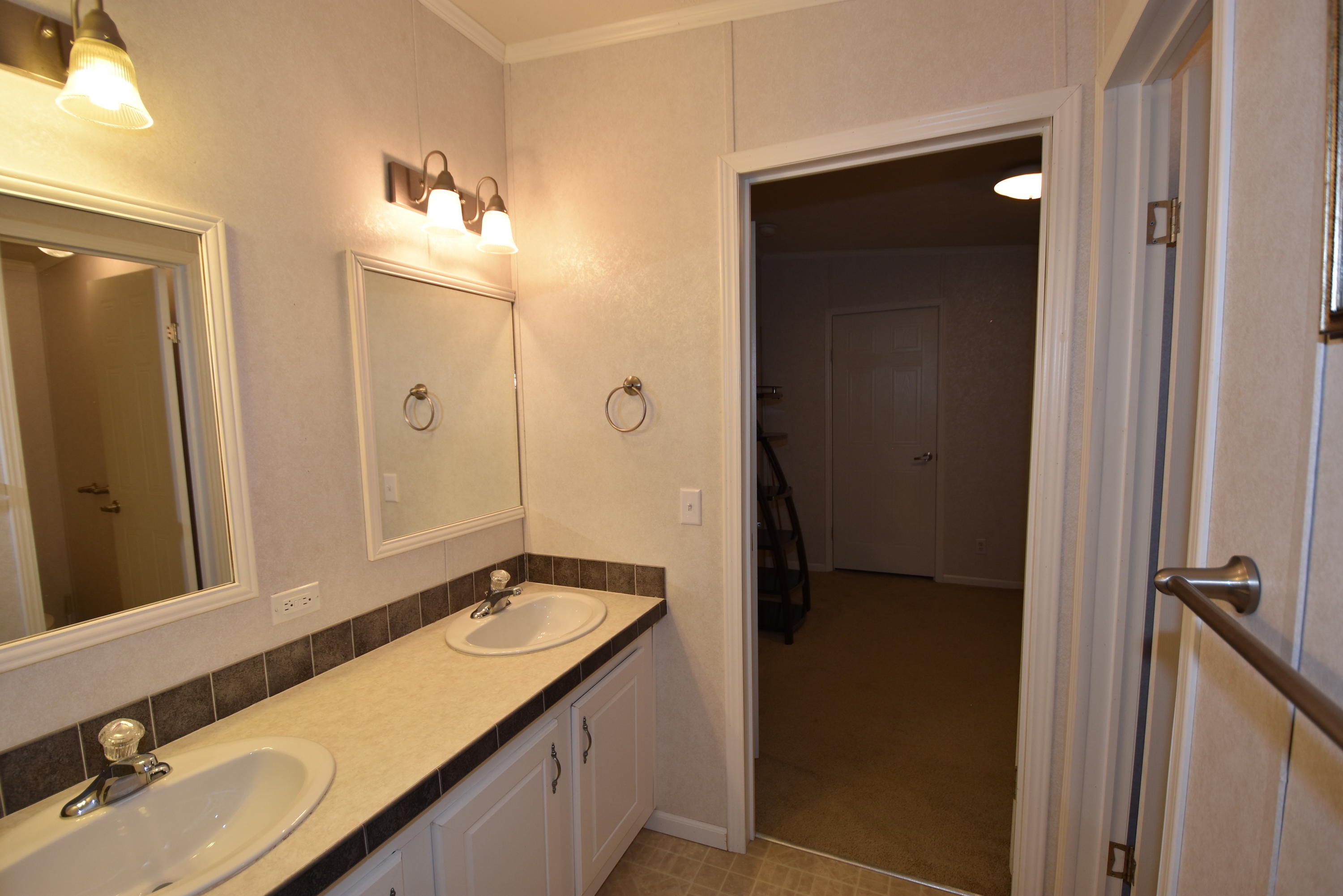 2953 Adams Road Crestview, FL 32536 - Photo 27 of 51 a bathroom with a sink and a mirror