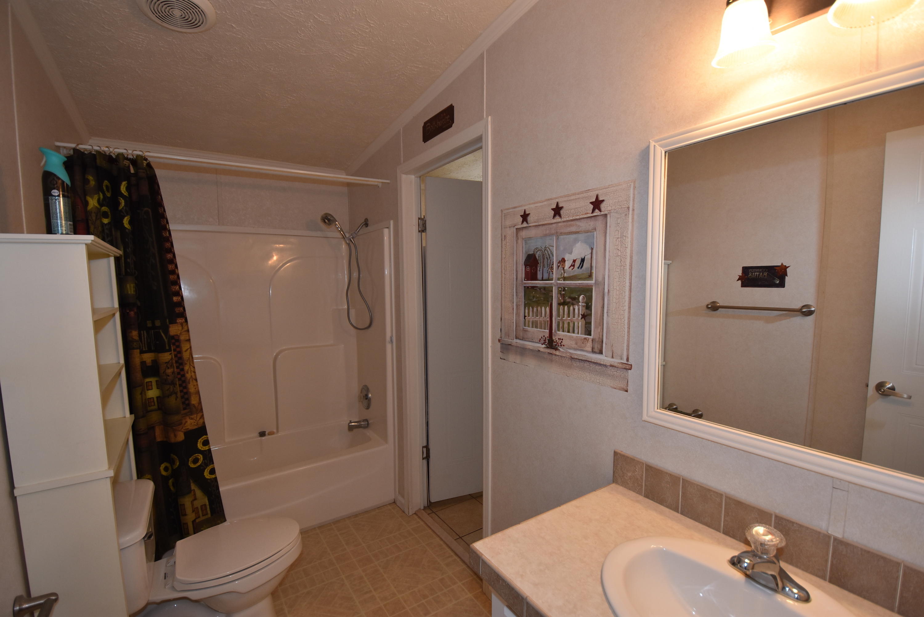 2953 Adams Road Crestview, FL 32536 - Photo 31 of 51 a bathroom with a sink a toilet and shower