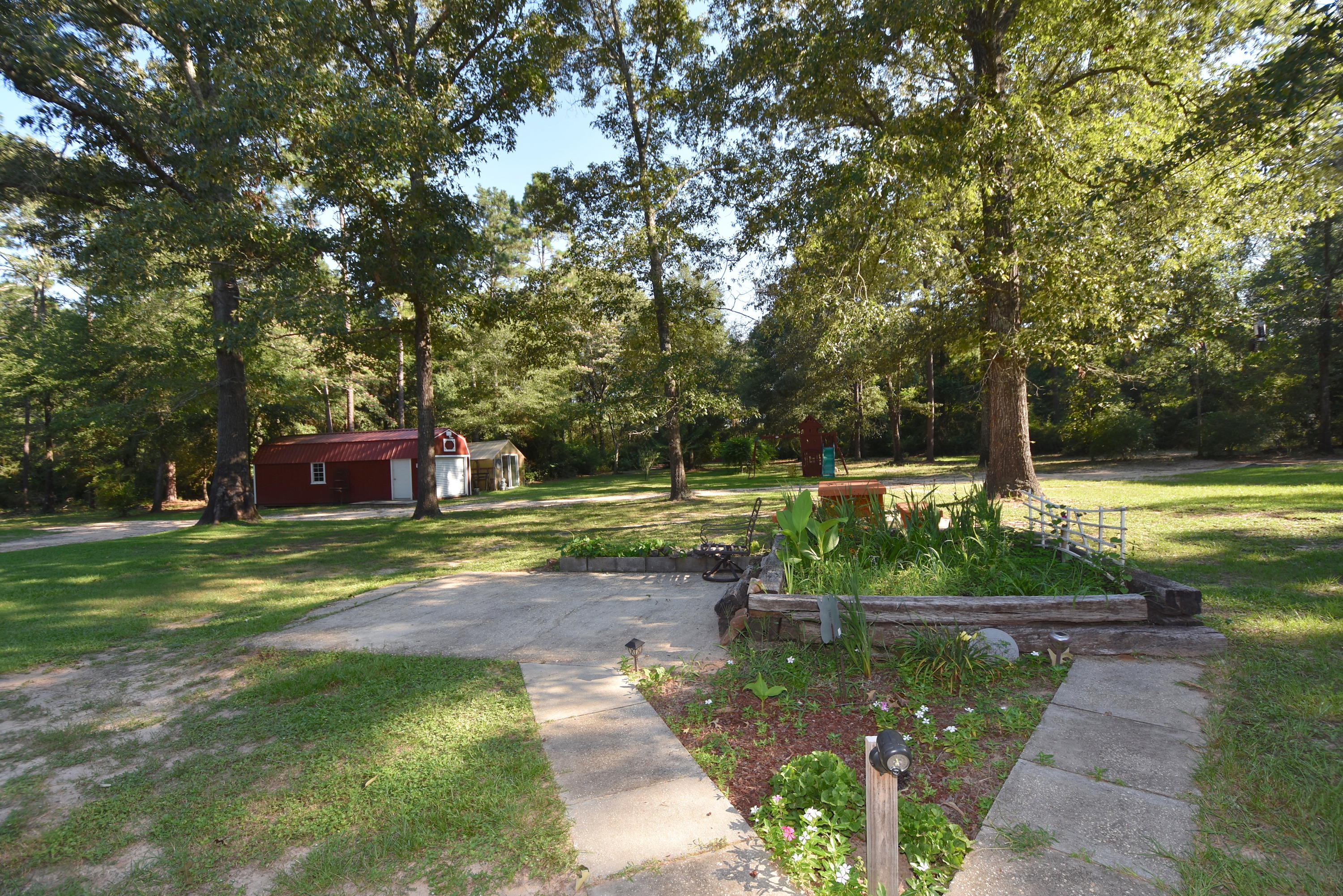 2953 Adams Road Crestview, FL 32536 - Photo 4 of 51 a view of a garden with plants