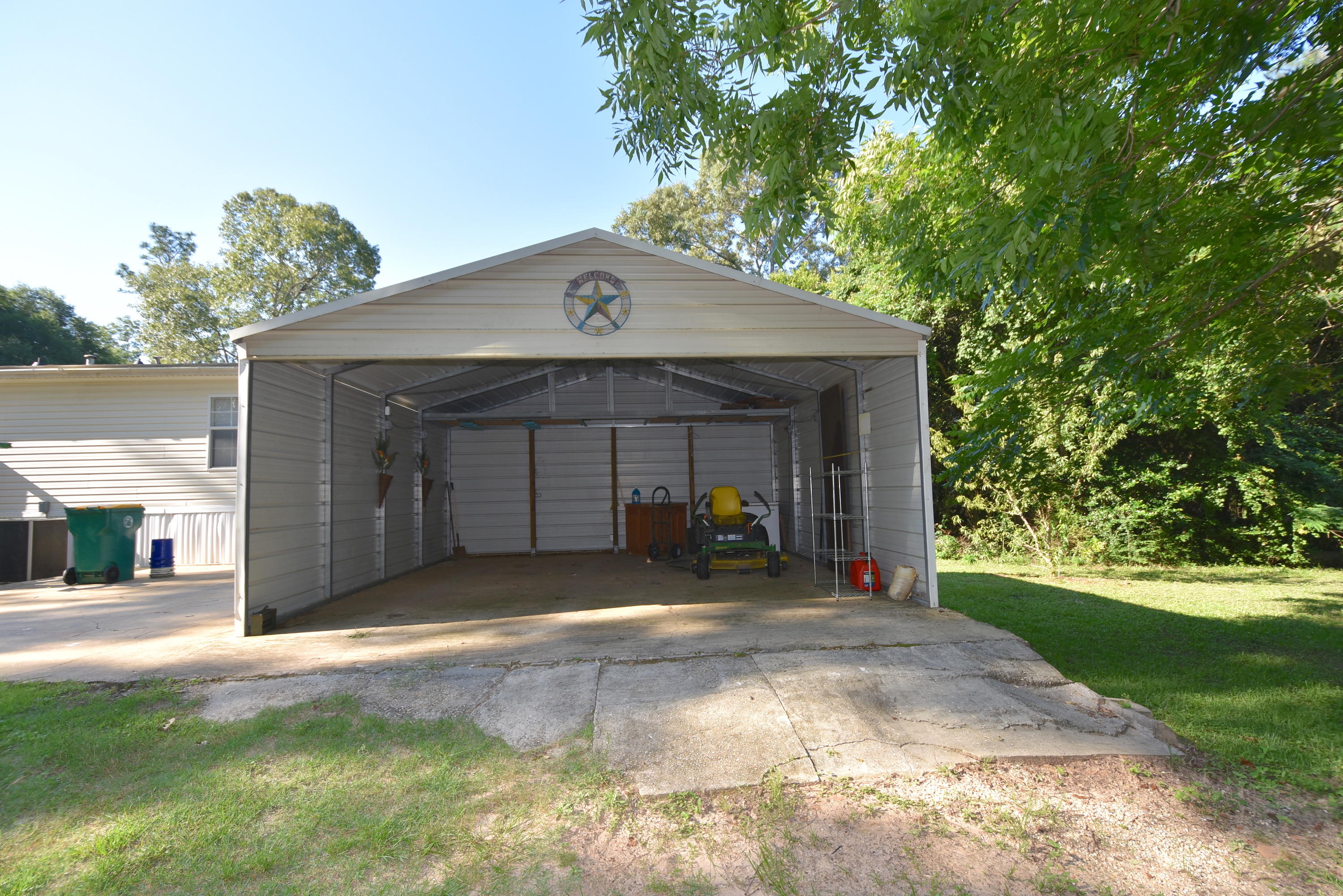 2953 Adams Road Crestview, FL 32536 - Photo 5 of 51 a front view of a house with a yard and garage