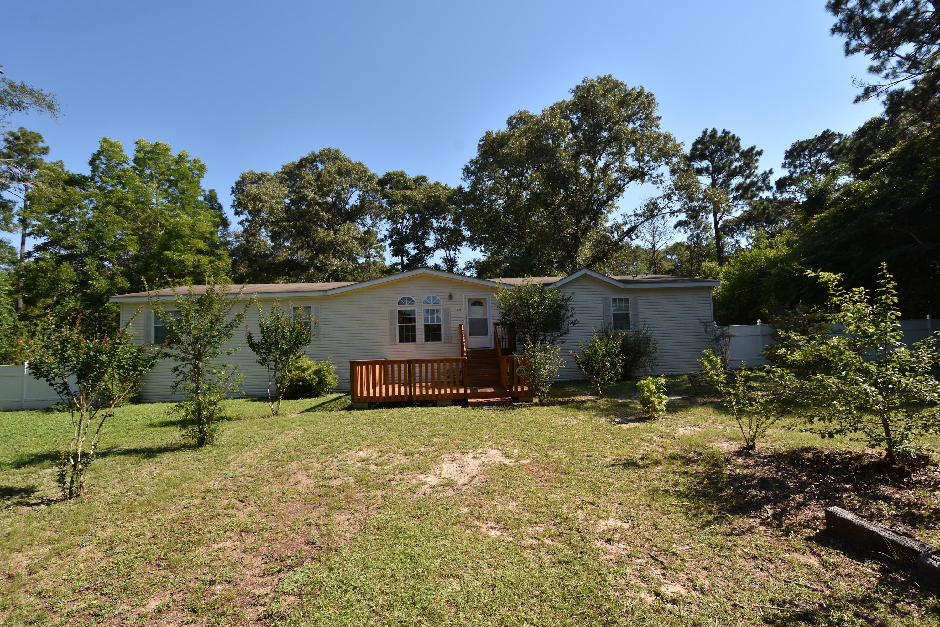 2953 Adams Road Crestview, FL 32536 - Photo 51 of 51 a house that has a tree in front of it