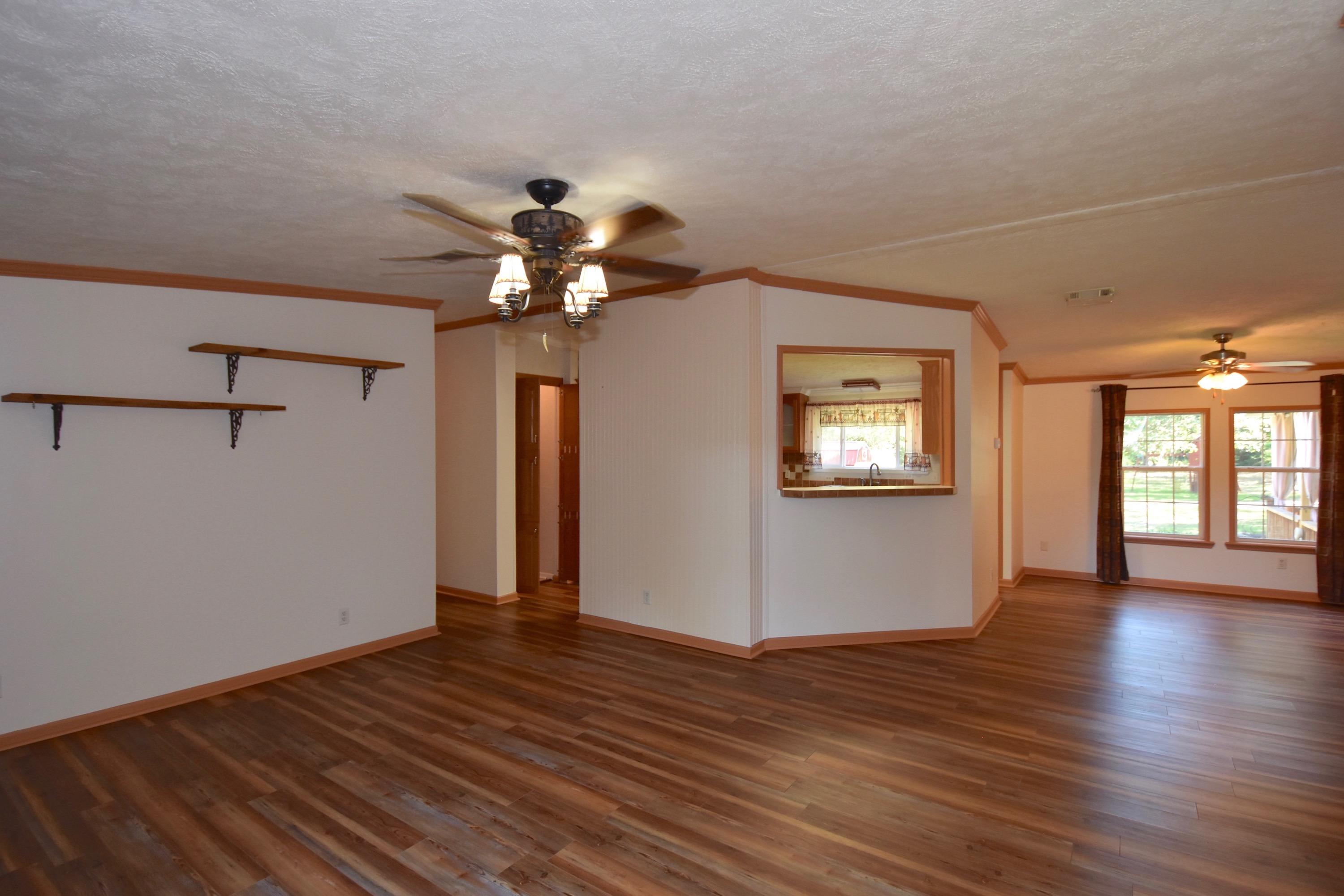 2953 Adams Road Crestview, FL 32536 - Photo 7 of 51 a view of an empty room with a window and wooden floor