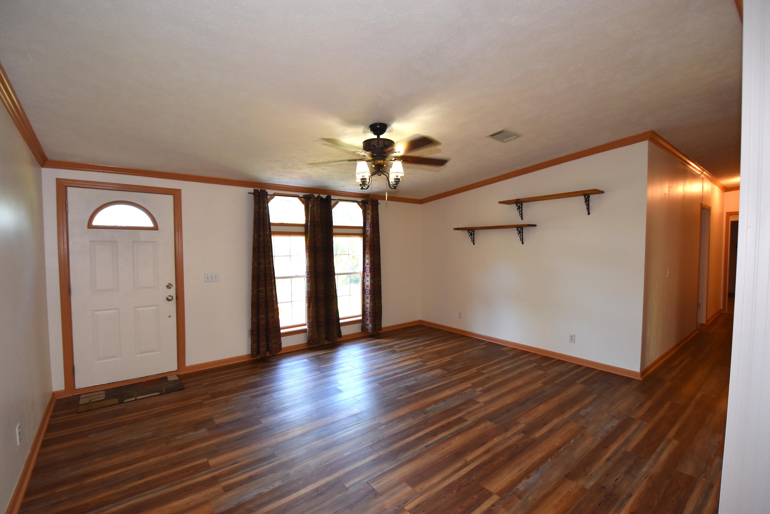 2953 Adams Road Crestview, FL 32536 - Photo 8 of 51 a view of an empty room with a window and wooden floor