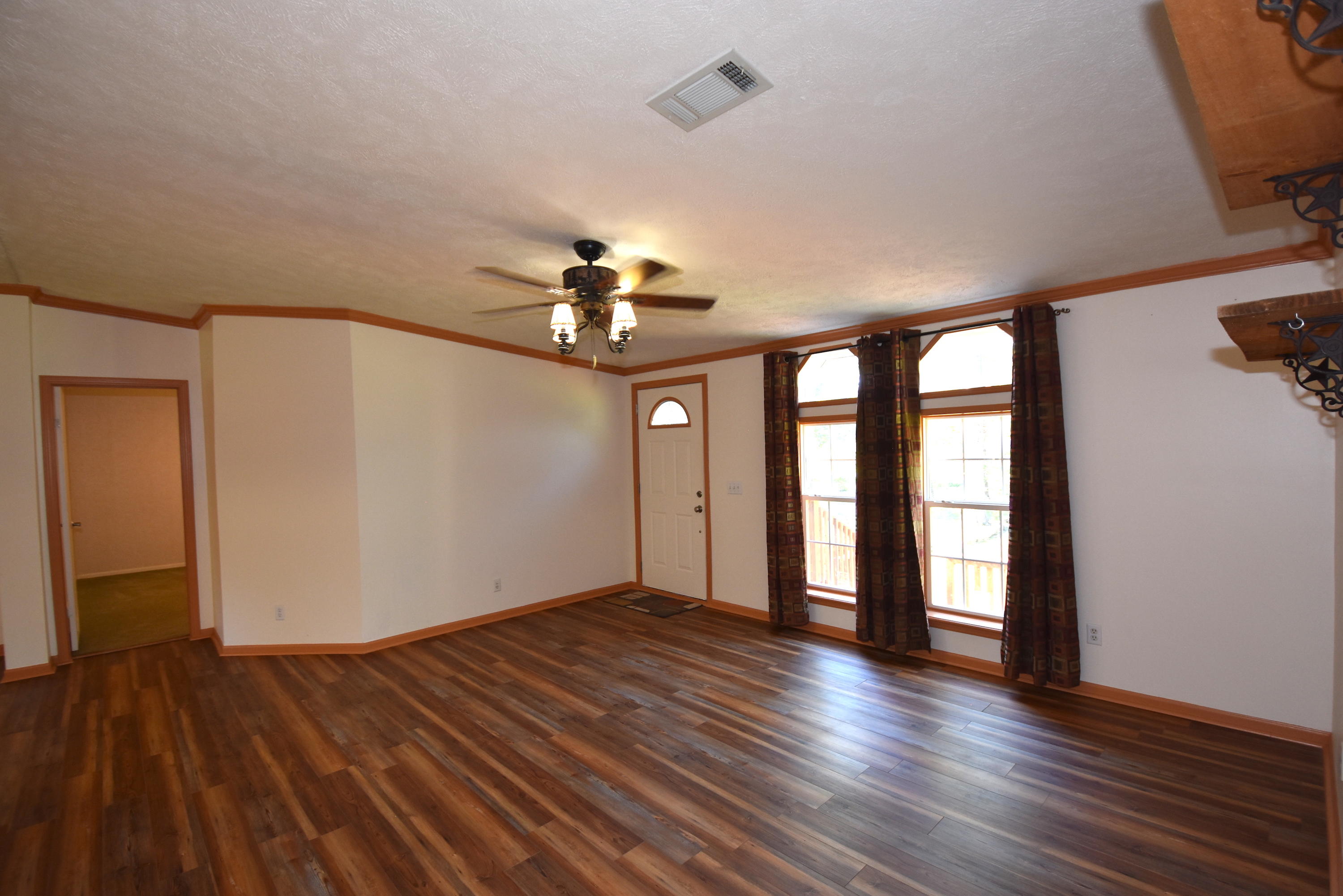 2953 Adams Road Crestview, FL 32536 - Photo 9 of 51 wooden floor in an empty room with a window