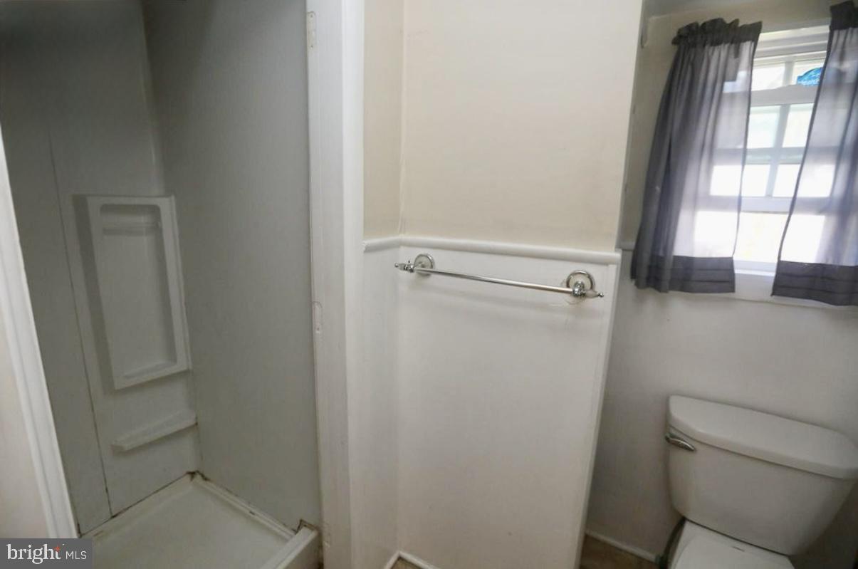 310 Ellis Street Glassboro, NJ 08028 - Photo 11 of 15 a bathroom with a toilet and a shower