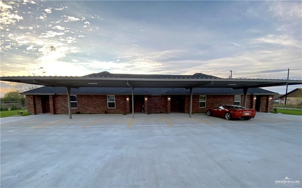 5206 Murillo Street, Unit 3 Edinburg, TX 78542 - Photo 1 of 9 a view of a house with a barbeque and large trees
