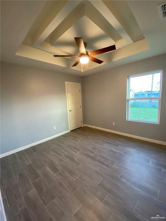 5206 Murillo Street, Unit 3 Edinburg, TX 78542 - Photo 6 of 9 an empty room with wooden floor ceiling fan and windows