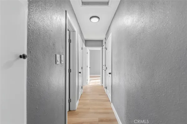 a view of a hallway with wooden floor