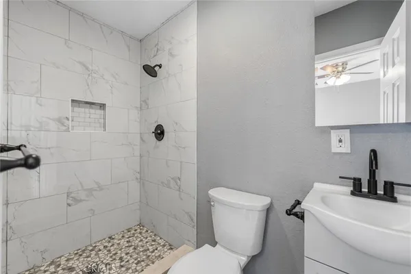a bathroom with a toilet a sink and shower