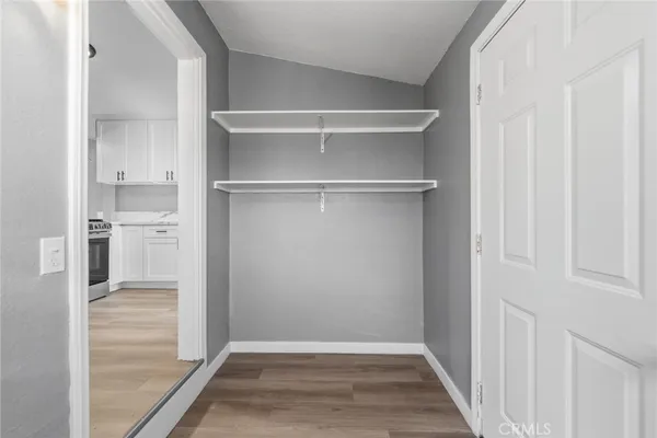 a view of walk in closet with empty racks
