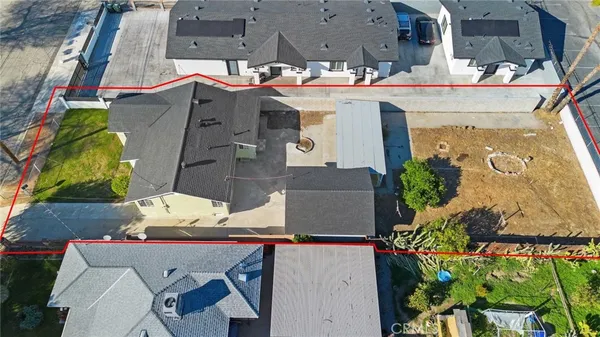 an aerial view of a house with a yard