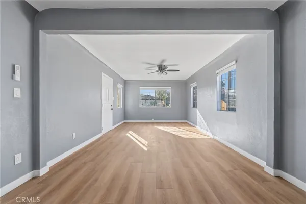a view of empty room with wooden floor