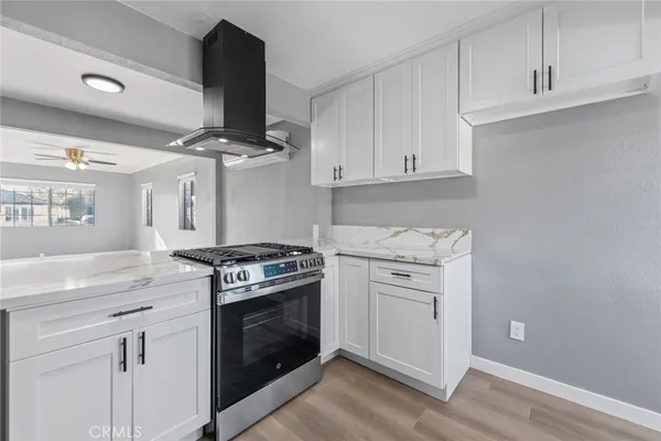 a kitchen with a stove oven and white cabinets