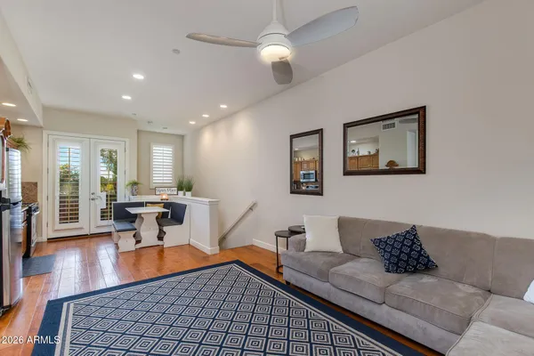 a living room with furniture and a dining table