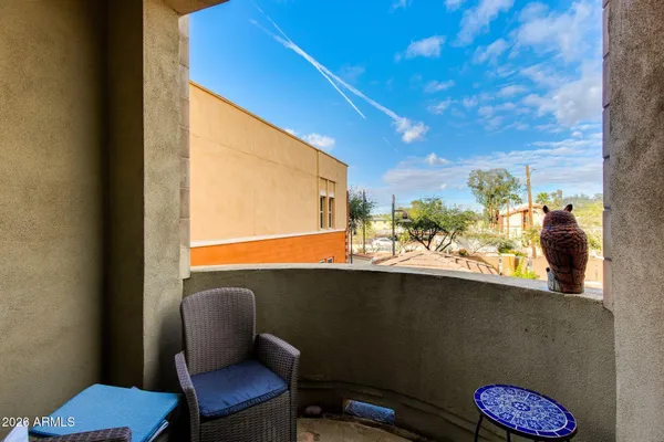 a view of a chair and table in a balcony