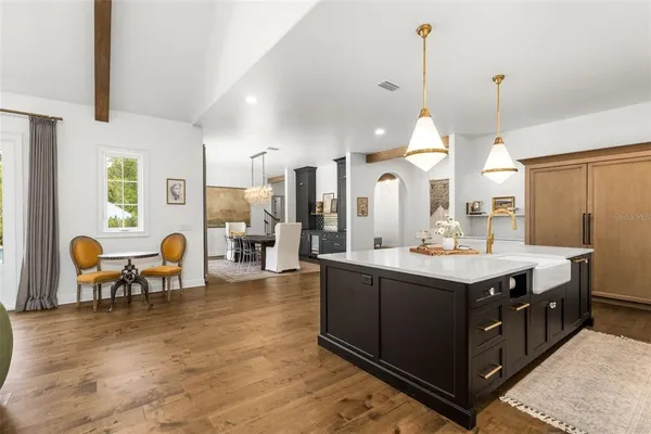 a large kitchen with a table and chairs