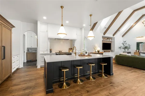 a dining room with furniture a chandelier and wooden floor