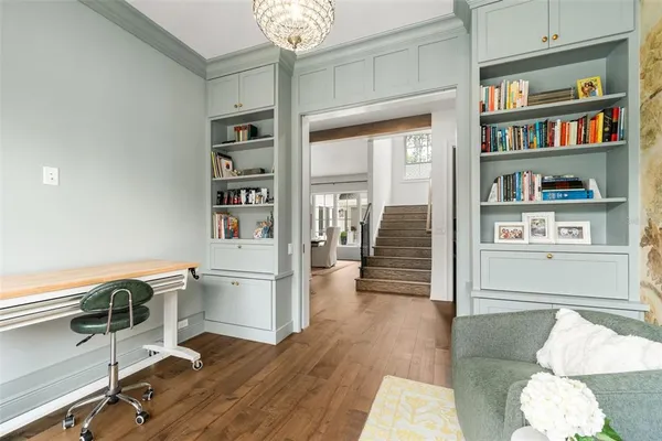 a view of entryway and hall with wooden floor