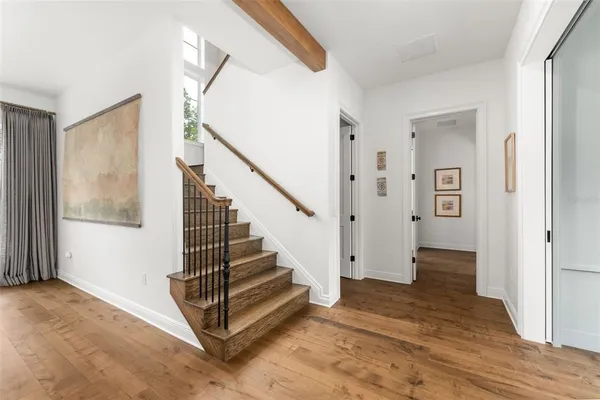 a bathroom with a sink a toilet and a large mirror