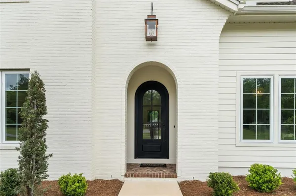 a front view of a house with plants