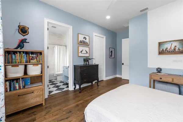 a kitchen that has a stove and a wooden floors