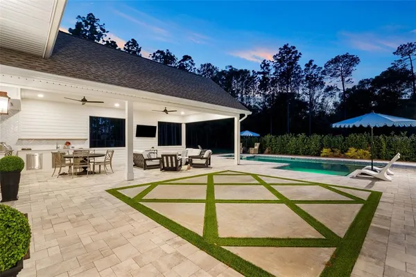 an aerial view of a house with a yard basket ball court and outdoor seating