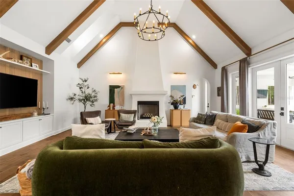 a living room with furniture fireplace and flat screen tv