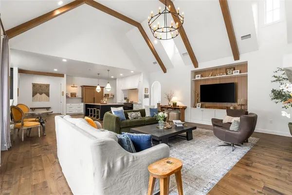 a living room with furniture wooden floor and a flat screen tv