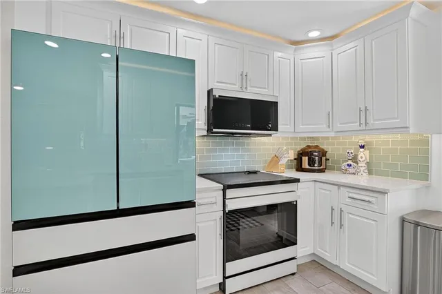 a kitchen with cabinets stainless steel appliances and wooden cabinets