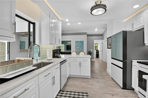 a kitchen with refrigerator and cabinets