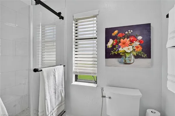 a bath room with a bed and a window