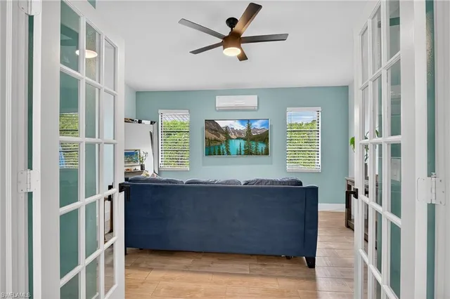 a living room with furniture and a dining table
