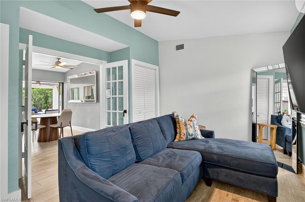 5270 Berkeley Drive Naples, FL 34112 - Photo 23 of 43 a living room with furniture and a dining table