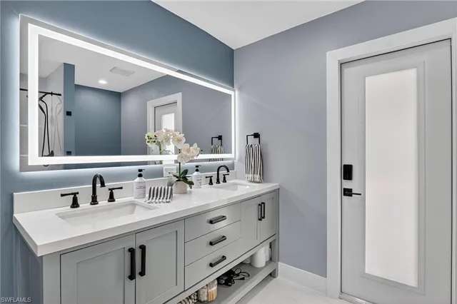 a bathroom with a sink and a mirror