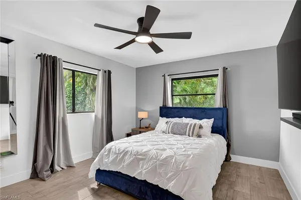 a bedroom with a bed and a painting on the wall