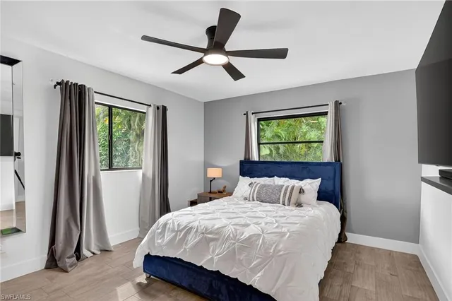 a bedroom with a bed and a painting on the wall